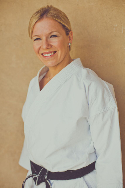 Claire Higgins smiling karate black belt profile picture